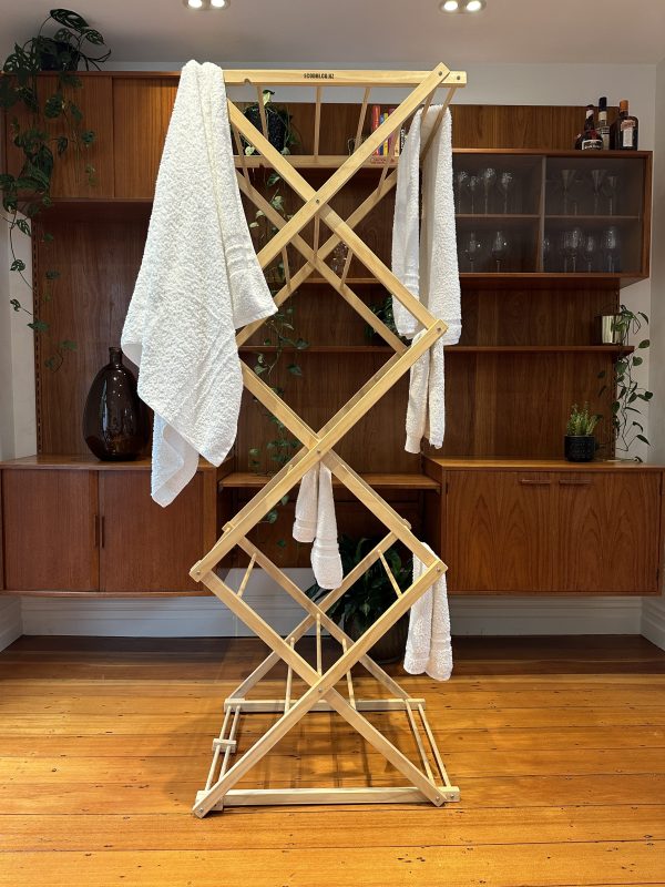 Tall timber clothes drying rack with white towels